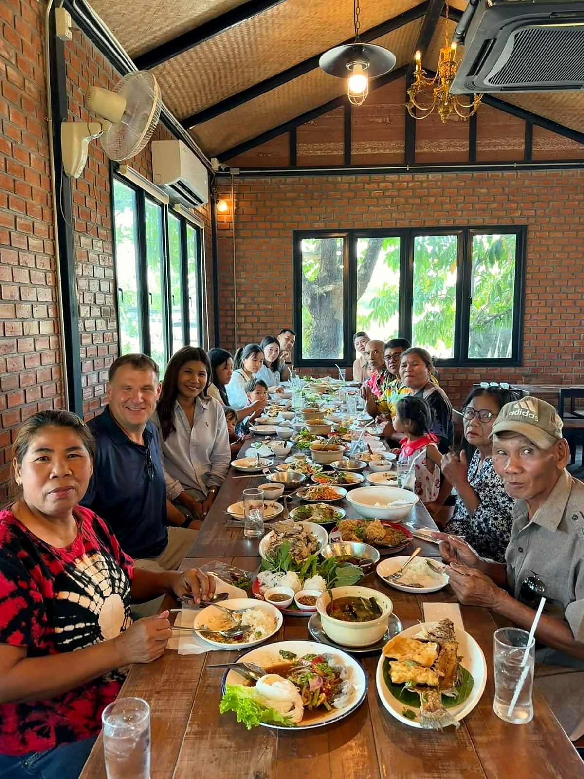 A long family table in Surin, Ploy's family sharing a meal